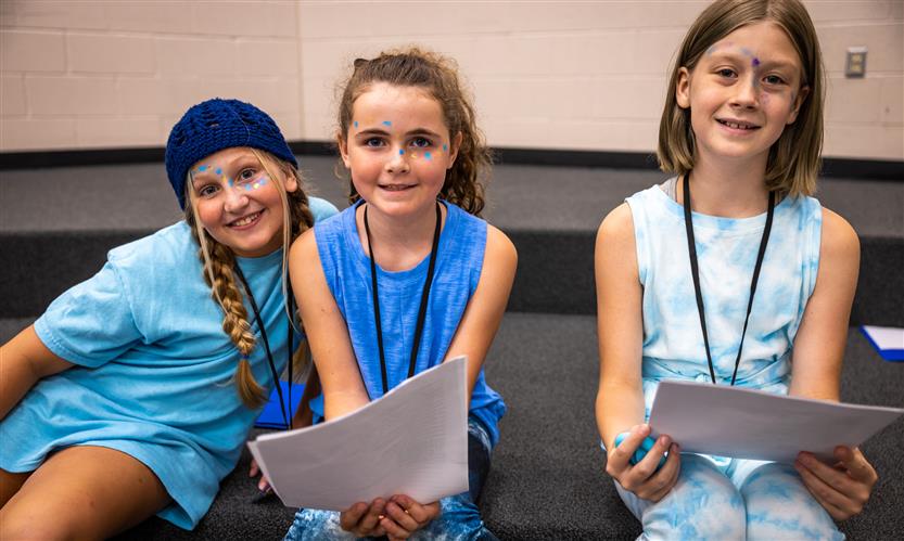 Three girls smile